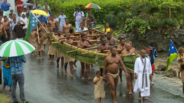 Father Jeke leads Fiji Melanesians who re-enacted the 1864 landing in a parade through the town of Levuka. (Photo: James Muller, Earth Base Productions)